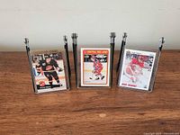 Three encased hockey cards on display stands