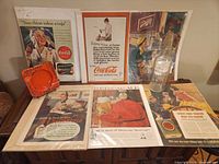 overview of ashtray, bottle, six advertisement pages