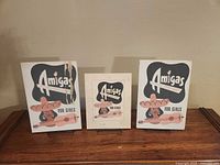 Front view of three Amigas advertising signs on stands