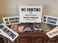 Overview showing seven Goodyear signs and assorted fishing gear on cabinet