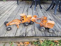 Both pressed-steel toys side by side on deck