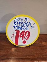 Front view of round Honest Ed's sign showing text and price