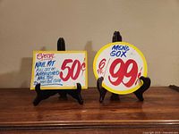 Both Honest Ed's signs on stands, front view