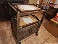 Full view of wooden rolling cart with trays and cabinet