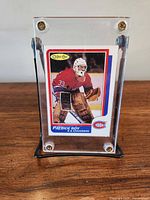 Front view of Patrick Roy rookie card in upright acrylic case