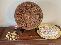 Overall lot showing plaque, trays, stamps, buttons