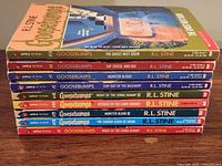 Stack of nine Goosebumps books showing titles on spines