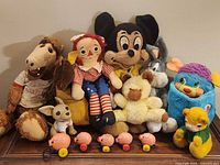 Group shot of all stuffed toys and pull toy on table