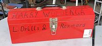 Closed red toolbox showing exterior markings and latch