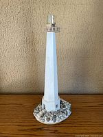 Full view of lighthouse lamp on wooden surface
