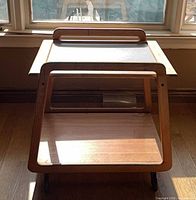 full frontal view showing two tiers and handle