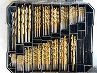 Open case showing assorted gold TiN-coated drill bits arranged by size