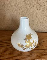 Front view showing gilt figure decoration and bulbous form