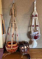All three macrame hangers with ceramic pots mounted on wall