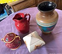 All four pottery pieces displayed on table