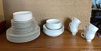 Entire set stacked: multiple plate sizes, bowls, six cups