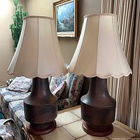 Pair of Bostlund pottery lamps with shades on side table
