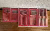 Five clear-lid cases showing complete sets of utensils