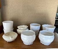 Group shot of all nine white pottery pieces