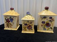 Front view of all three hand painted ceramic canisters