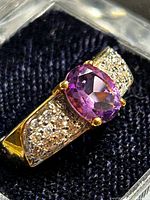 Close-up of ring showing amethyst and pavé stones