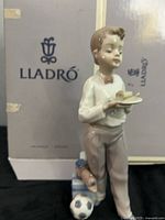 Front view of Lladro figurine with box backdrop