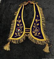 Full view of collar showing color, fringe, and emblems