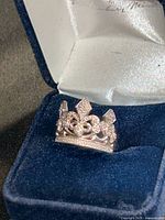 Sterling silver crown ring inside blue velvet box