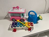 Group shot showing xylophone, ice cream truck toy and watering can
