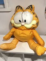 Front view of oversized Garfield plush