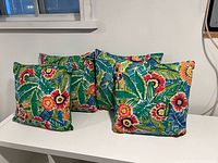 Front view of four cushions showing floral pattern