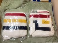 Two packaged Hudson’s Bay striped towels side by side