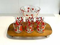 Full set displayed on tray: six tumblers, bowl, teak tray