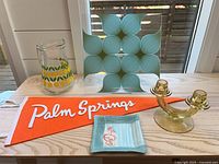 Group shot of all five items: pennant, pitcher, tray, candelabra, dish