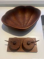 Top view of teak bowl and full condiment set