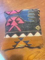 Front view showing geometric kilim design and colour palette