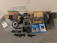 All items laid out including pedals, crankset, saddle, small parts