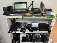 Overall view of three shelves containing all listed electronics and accessories