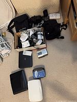 Group shot of all electronics, cords, cases and modules on carpet