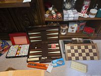 All game sets together showing backgammon, Mahjong, dominoes, cribbage board and shuffler
