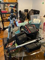 Overall view of tripod, monopod and camera bags on table