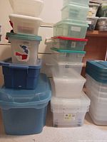 Two stacks of assorted plastic storage containers with lids