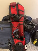 Red/black tool roll with light, pannier and saddle bags behind