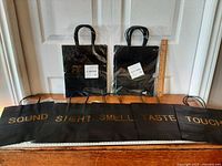 All five bag designs laid out plus two packaged sets with ruler for scale