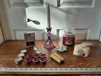overview of all candles and holders on wooden surface
