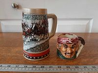 Front view of both stein and toby jug with ruler for scale