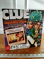 Front of Clue Carnival game box showing title, artwork, age recommendation