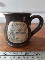 Full view of Deneen Pottery mug with measurement scale
