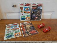 Overall lot with four sticker packs and two pull-back cars displayed