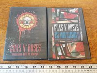 Both DVD cases front covers with ruler for scale